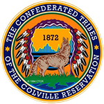 Circular Colville Confederated Tribes logo featuring a howling coyote, a mountain range graphic, a headdress, and the year 1872