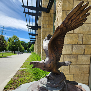 A bronze sculpture of an eagle in flight.